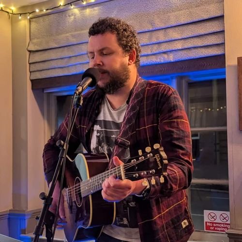 Jack playing guitar at the Bull in Broughton