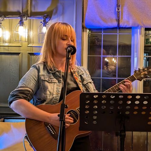 Tasha playing guitar at the Bull in Broughton